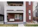 Charming townhome features a cozy porch swing and classic brick and stucco facade at 1733 Irving St # 101, Denver, CO 80204