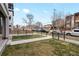 Townhouse front yard features simple landscaping, metal fence, and a concrete walkway at 1733 Irving St # 101, Denver, CO 80204