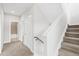 Bright hallway with carpet, bathroom, and staircase featuring modern neutral tones and textures at 1733 Irving St # 101, Denver, CO 80204