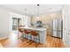Modern kitchen with light wood cabinets, stainless appliances, large island and hardwood floors at 1733 Irving St # 101, Denver, CO 80204