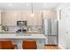 Modern kitchen featuring a large island, stainless steel appliances and light wood cabinets at 1733 Irving St # 101, Denver, CO 80204