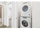 Convenient laundry area with stacked washer and dryer units, maximizing space in a modern home at 1733 Irving St # 101, Denver, CO 80204