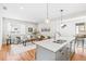 Open concept living area with hardwood floors and a view to the kitchen and dining area at 1733 Irving St # 101, Denver, CO 80204