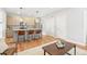 Open floor plan with a living room, kitchen, and dining area featuring modern furnishings and hardwood floors at 1733 Irving St # 101, Denver, CO 80204