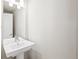 Modern powder room featuring a pedestal sink and white walls at 1733 Irving St # 101, Denver, CO 80204