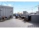 A spacious rooftop deck provides plenty of room for outdoor seating and entertaining under the string lights at 1733 Irving St # 101, Denver, CO 80204