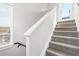 Bright stairway featuring plush, neutral carpeting, and a white handrail leading to the upper levels at 1733 Irving St # 101, Denver, CO 80204