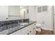 Bright bathroom featuring granite countertops and white cabinets at 5890 W Quarles Dr, Littleton, CO 80128