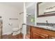 Bright bathroom with granite countertops, a wood vanity, and wood flooring at 5890 W Quarles Dr, Littleton, CO 80128