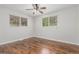 Sunlit bedroom with hardwood floors and light walls at 5890 W Quarles Dr, Littleton, CO 80128