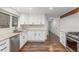 Bright kitchen featuring stainless steel appliances, white cabinets, and hardwood floors at 5890 W Quarles Dr, Littleton, CO 80128
