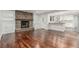 Beautiful living room featuring hardwood floors, fireplace, built-in shelving and an open layout at 5890 W Quarles Dr, Littleton, CO 80128