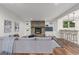 Bright living room with a cozy fireplace, built-in shelving, and a modern, comfortable design at 5890 W Quarles Dr, Littleton, CO 80128