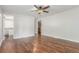 Spacious bedroom featuring hardwood floors, a ceiling fan, and neutral walls at 5890 W Quarles Dr, Littleton, CO 80128
