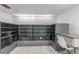 Bright office space with gray built-in shelves and desk and neutral carpet at 5890 W Quarles Dr, Littleton, CO 80128