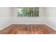 Spacious room featuring hardwood floors and a large window with natural light at 5890 W Quarles Dr, Littleton, CO 80128