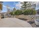 Backyard patio with stone retaining wall and mature trees at 10440 Olathe, Commerce City, CO 80022