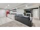 Finished basement with a kitchenette, fireplace, tv, and an oversized black leather sofa at 10440 Olathe, Commerce City, CO 80022