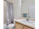 Bathroom featuring a vanity with cream countertop, patterned shower curtain, and a large mirror at 10440 Olathe, Commerce City, CO 80022