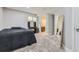 Carpeted bedroom featuring a vanity table, large mirror, and neutral walls at 10440 Olathe, Commerce City, CO 80022