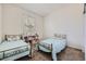 Bedroom showcasing two twin beds, carpet floors, a window with blinds, and a white storage unit at 10440 Olathe, Commerce City, CO 80022
