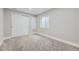 Bedroom showcasing closet, a window with blinds, neutral paint, and carpet flooring at 10440 Olathe, Commerce City, CO 80022