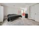 Bedroom featuring carpeted floors, black mini fridge, red velvet chair, shelving and double door closet at 10440 Olathe, Commerce City, CO 80022