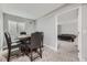 Carpeted dining area with dark wood table and chairs, view to bedroom at 10440 Olathe, Commerce City, CO 80022