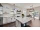 Bright kitchen featuring white cabinets, subway tile backsplash, and a large center island with quartz countertop at 10440 Olathe, Commerce City, CO 80022