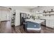 Modern kitchen with white cabinets, stainless steel appliances, and a center island at 10440 Olathe, Commerce City, CO 80022