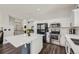 Stylish kitchen featuring a white island, stainless steel appliances, and hardwood floors at 10440 Olathe, Commerce City, CO 80022
