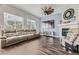 Spacious living room with a fireplace, large windows, and hardwood floors at 10440 Olathe, Commerce City, CO 80022