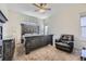 Bedroom with gray distressed wood furniture, carpet floors, a ceiling fan, and two windows at 10440 Olathe, Commerce City, CO 80022