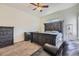 Bedroom featuring distressed furniture, carpet floors, windows, and a black leather chair at 10440 Olathe, Commerce City, CO 80022