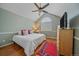 Bright bedroom featuring vaulted ceilings, a ceiling fan, and hardwood floors creating a welcoming and cozy retreat at 10389 W Fair Ave # E, Littleton, CO 80127