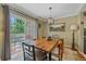 Well-lit dining room with a wood table and chairs, next to sliding glass door at 10389 W Fair Ave # E, Littleton, CO 80127