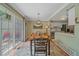 Charming dining area with sliding glass doors and adjacent kitchen at 10389 W Fair Ave # E, Littleton, CO 80127