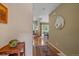 Inviting hallway view leading to an open living space and dining area, complete with hardwood floors at 10389 W Fair Ave # E, Littleton, CO 80127