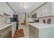 Bright kitchen with white cabinets, stainless steel appliances, and modern tile backsplash at 10389 W Fair Ave # E, Littleton, CO 80127