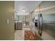 Open kitchen with stainless steel appliances, tile flooring, and view of dining room at 10389 W Fair Ave # E, Littleton, CO 80127