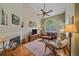 Cozy living room with a fireplace, vaulted ceiling, and ample natural light at 10389 W Fair Ave # E, Littleton, CO 80127