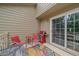 Comfortable patio area featuring a grill, outdoor seating, and sliding glass doors for easy access at 10389 W Fair Ave # E, Littleton, CO 80127