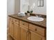 Bathroom vanity with granite countertop, wood cabinets, and stylish fixtures at 9725 E Harvard Ave # 434, Denver, CO 80231