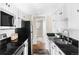 Charming galley kitchen with black countertops, white subway tile, and stainless appliances at 9725 E Harvard Ave # 434, Denver, CO 80231