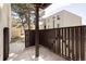 Patio with wood railing offering a private outdoor space and view of complex buildings at 9725 E Harvard Ave # 434, Denver, CO 80231