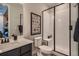 Modern bathroom featuring a walk-in shower with a glass door, stylish black framed art, and contemporary fixtures at 14160 Bunny Hop Ln, Parker, CO 80134