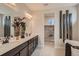 Bathroom with double vanity, soaking tub, and view into walk-in closet at 14160 Bunny Hop Ln, Parker, CO 80134