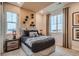 Cozy bedroom with a modern design, featuring a comfortable bed and stylish decor with natural light streaming through the window at 14160 Bunny Hop Ln, Parker, CO 80134
