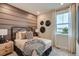 Cozy bedroom with modern decor, a comfortable bed, and natural light from the window at 14160 Bunny Hop Ln, Parker, CO 80134