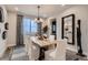 Elegant dining room with a modern chandelier, a large window with views, and a stylish mirror at 14160 Bunny Hop Ln, Parker, CO 80134